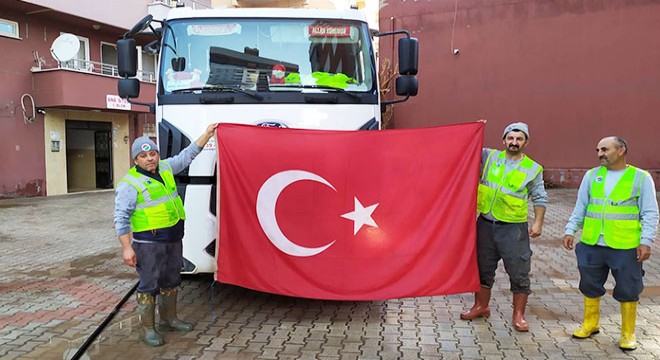 Çamurun içinde kalan Türk bayrağını yıkadılar