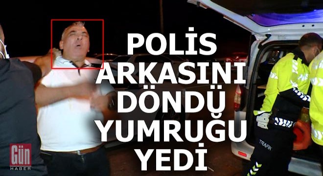 Polis arkasını döndü, yumruğu yedi