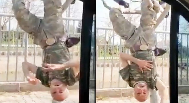 Yaşlı adam ağaca baş aşağı asılıp komando marşı söyledi